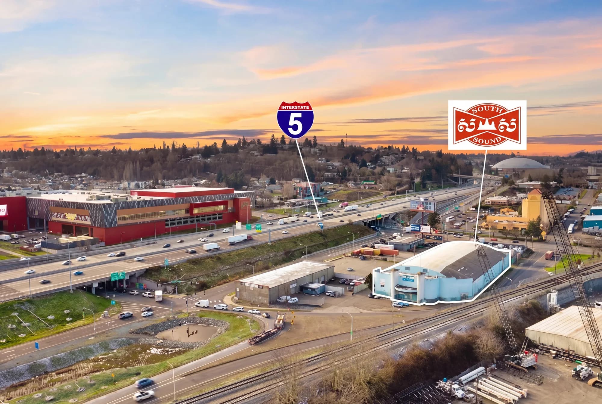 Aerial view of the gym beside Interstate 5 in Tacoma, with the Tacoma Dome visible